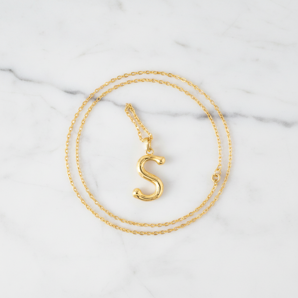 Gold Letter S on White Marble