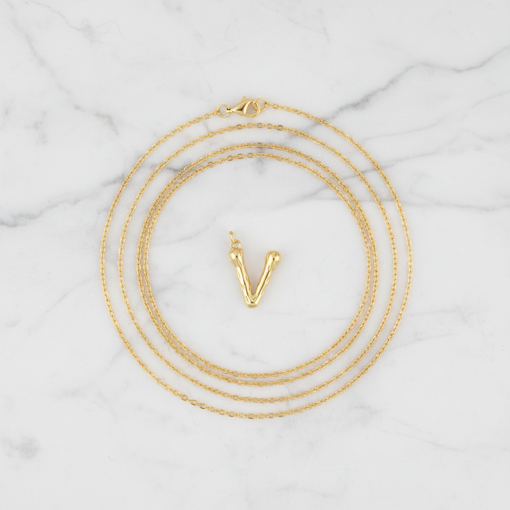 Gold Letter V on White Marble