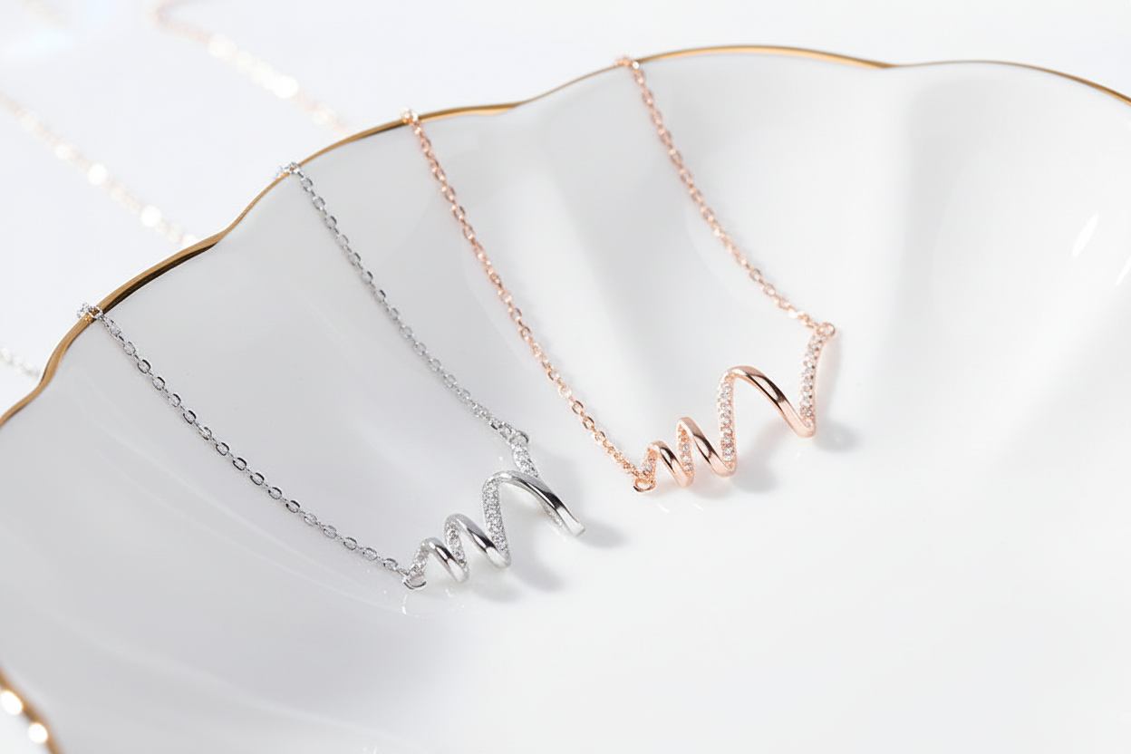 Silver and Rose Gold Heartbeat Necklaces on White Display